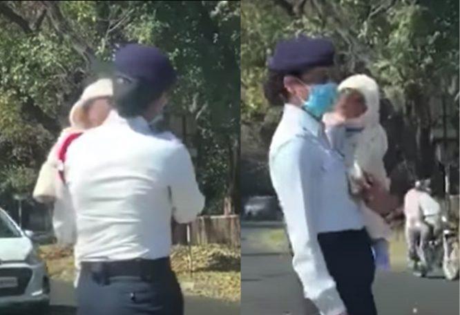 Polis Wanita Terpaksa Bertugas Jaga Lalu Lintas Sambil Dukung Anaknya Yang Masih Kecil